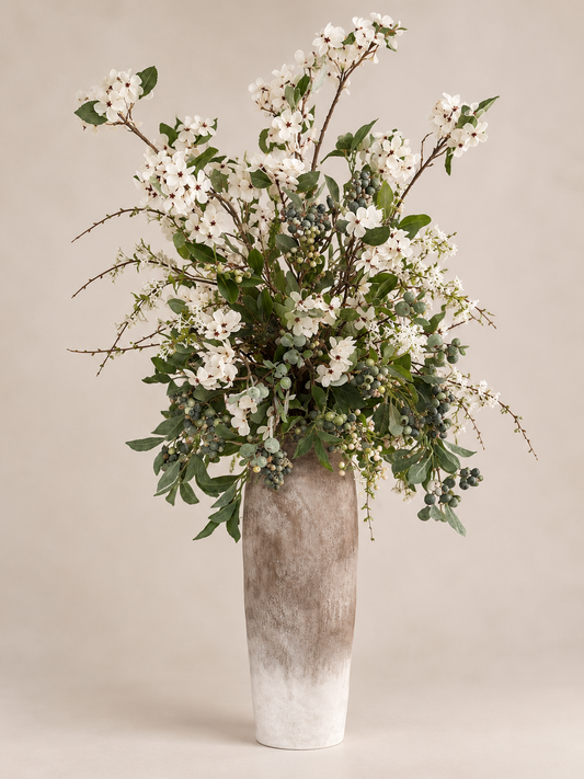 Daphne white floral arrangement with greenery and berry-like details in a textured ombre vase